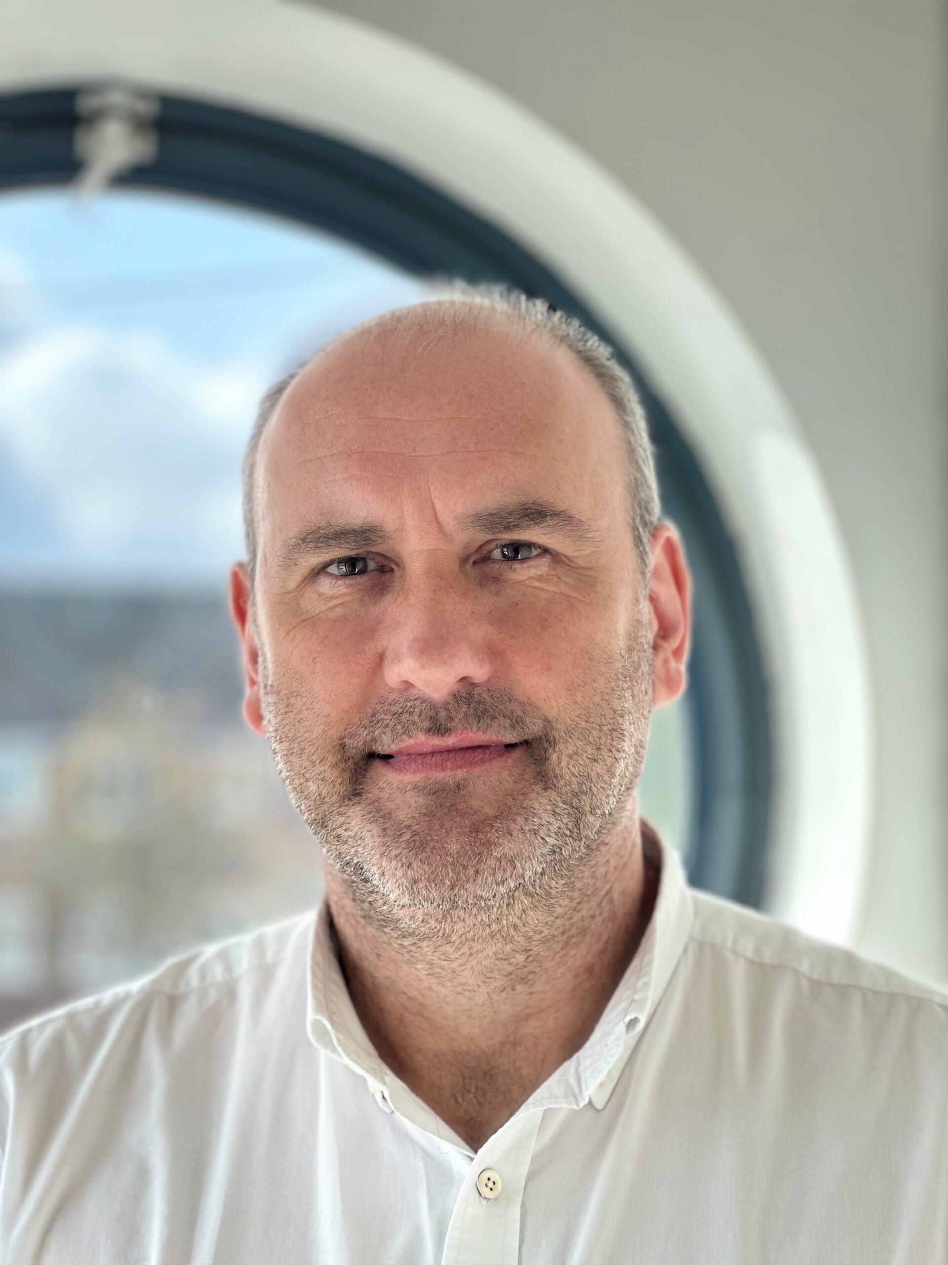 Dr Paul Shaw wearing a white shirt